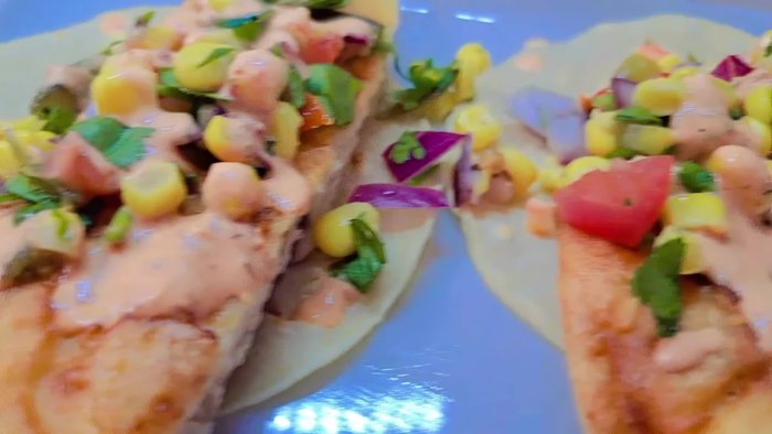 Prepare the corn pico de gallo: Combine corn, tomato, purple onion, cilantro, jalapenos (pickled or fresh), and vinegar. Add salt to taste. (Note: A separate recipe for the pico de gallo is mentioned in the video.)