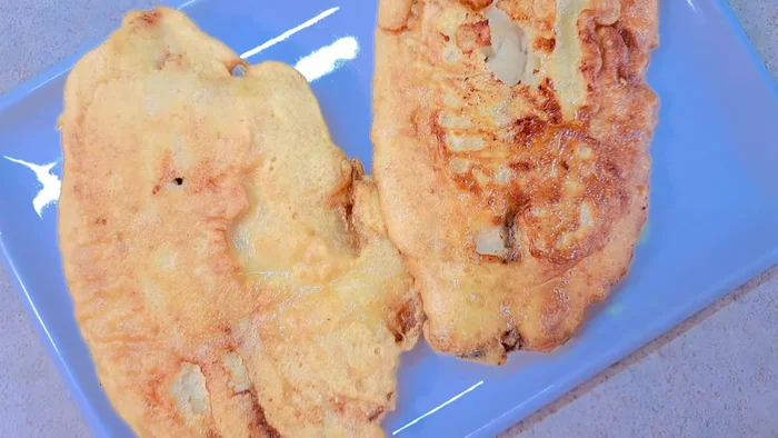 Cut the cooked tilapia fillets in half.