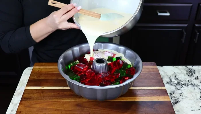 Add Cream Mixture: Pour the creamy Jello mixture over the layered Jello, ensuring all pieces are covered.