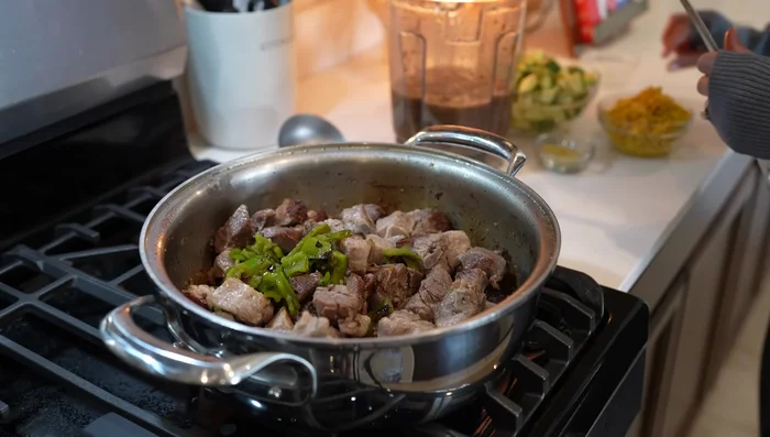 Add roasted hash peppers, corn, and the sauce to the meat. Add more water if needed. Bring to a simmer, then taste and adjust salt.