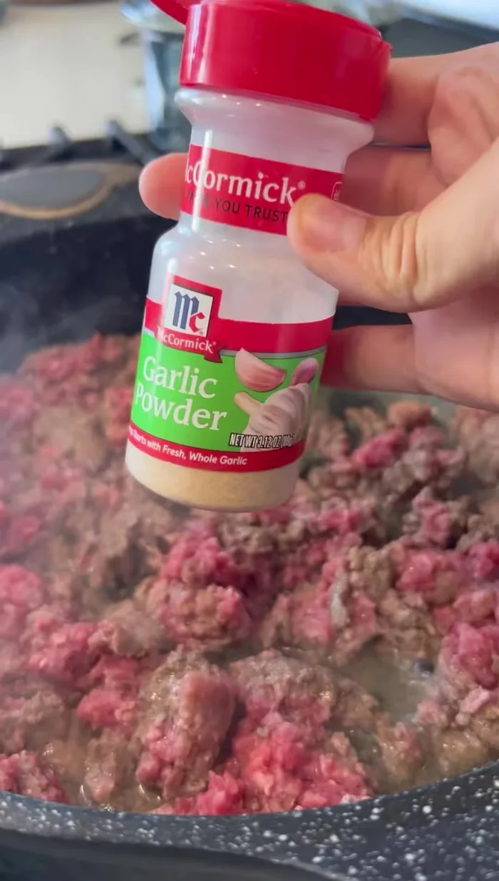 Cook the ground meat with garlic powder, pepper, and salt.