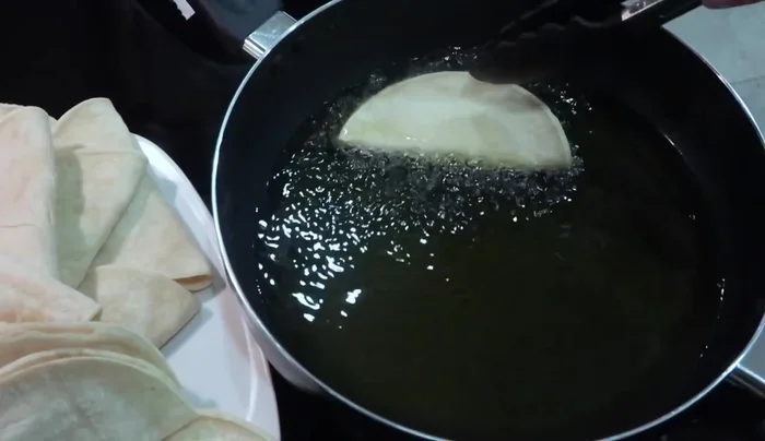 Heat oil in a skillet over medium flame. Fry the tacos for about a minute or two on each side until golden brown. Remove and place on a napkin-lined plate to absorb excess oil.