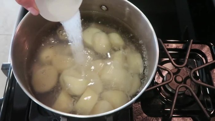 Boil potatoes in salted water for 20 minutes until fork tender. Drain well and transfer to a mixing bowl.