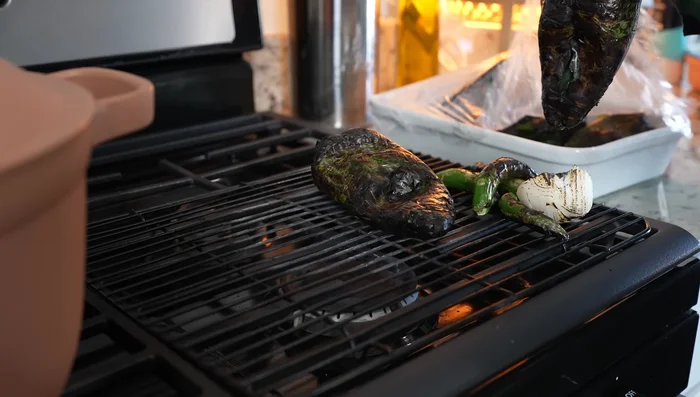Place roasted peppers in a bag to sweat for 10 minutes, then peel.