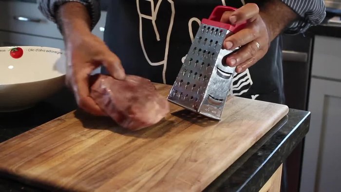 Turn 1 pound of frozen tuna into ground fish using a handheld grater.