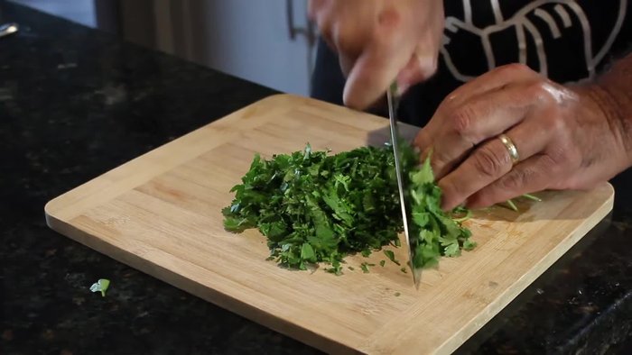 In a mixing bowl, combine the ground tuna, 1 egg, 1 bundle of chopped cilantro, juice of 1 lime, salt, and pepper.