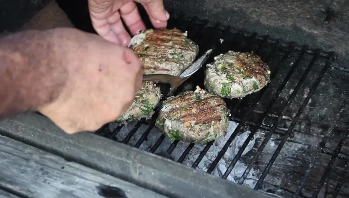 Grill the tuna patties. Once they are almost cooked, add a generous amount of cheddar cheese.