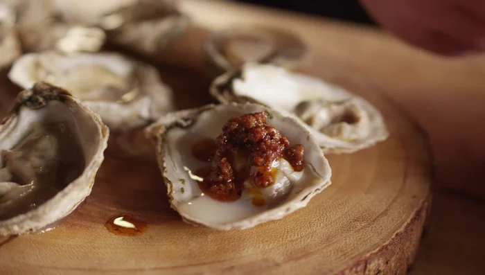 Spoon chorizo butter over the grilled oysters.
