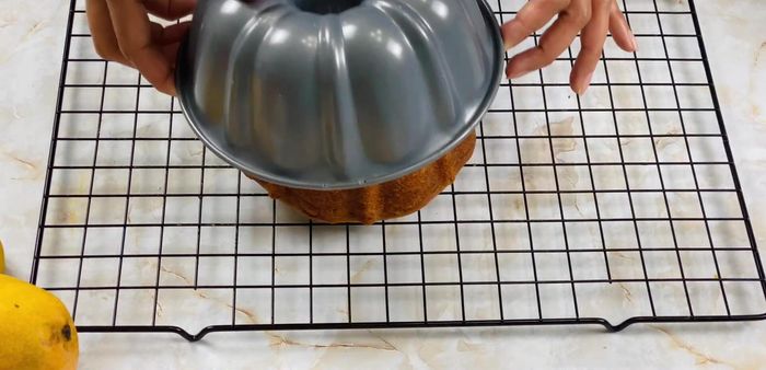 Let the cake cool for about 10 minutes before frosting.