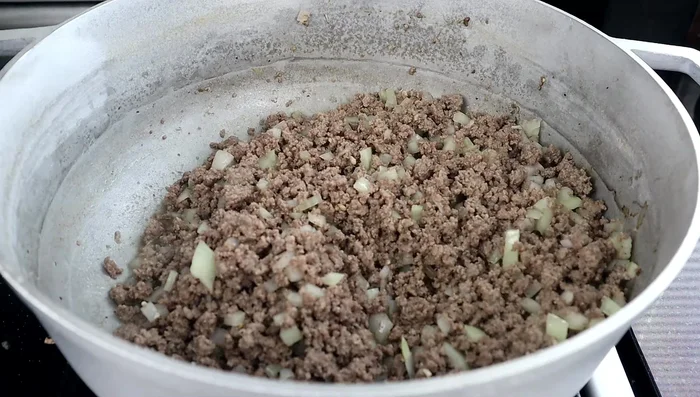Add carrots, taco seasoning, stewed tomatoes, cabbage, beef broth, salt, pepper, and water.