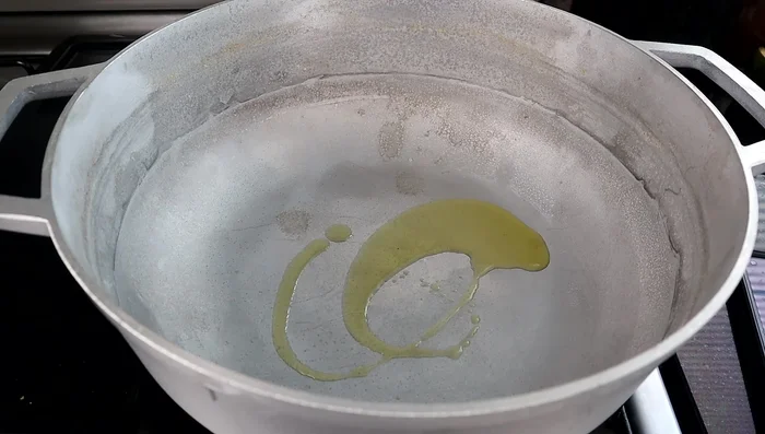 Heat 1-2 teaspoons of olive oil in a large pot over medium-high heat.