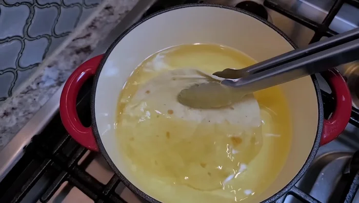 Carefully place flour tortillas into the hot oil and fry until deep golden brown and crispy, shaping them into the chalupa form as they fry. Flip to ensure even cooking.