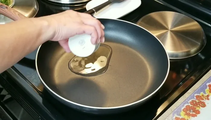 Heat 2 tablespoons of vegetable oil in a skillet. Add 3 serrano peppers (seeds removed or left in, to taste).
