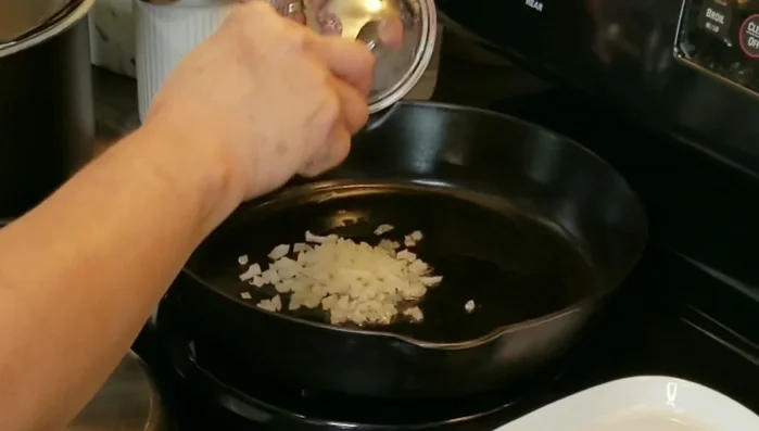 Sauté 1/4 of a small onion in bacon grease (or vegetable oil) until slightly toasty.