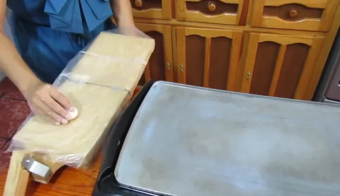 Make the tortillas: Shape corn dough into small balls and flatten them on a hot griddle.