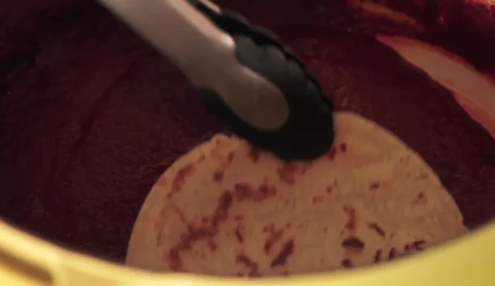 Fill the tortillas with the prepared vegetables and drench them in the chili sauce.