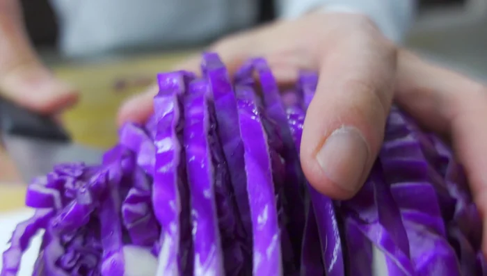 While the fish cooks, prepare the toppings. Chop the purple cabbage, red onion, avocado, and parsley (or cilantro).
