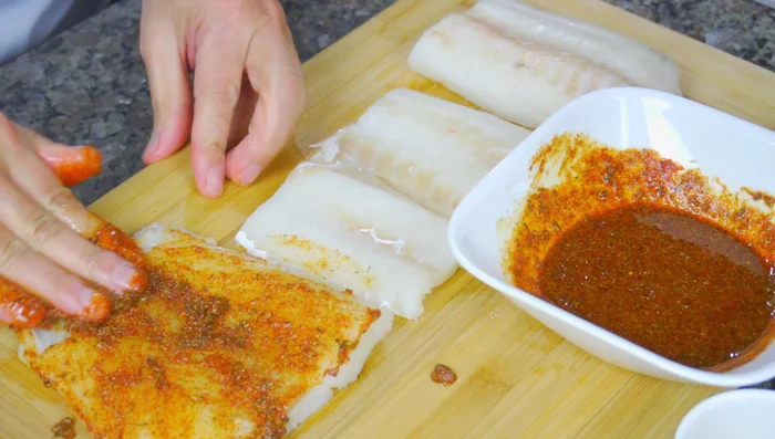 Season the fish generously with the mixture, ensuring all parts are coated.