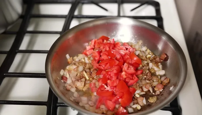 Add tomatoes to the skillet and cook until softened.