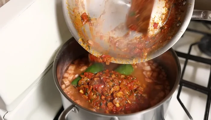 Add the stir-fried mixture to the almost-cooked beans. Stir gently to combine.