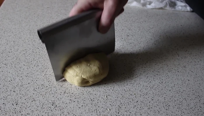 Divide the dough into 8 equal portions and form them into balls. Cover with a damp paper towel to prevent drying.