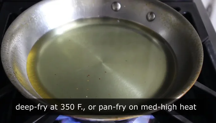 Heat oil in a skillet over medium-high heat. Carefully slide the flattened dough into the hot oil.