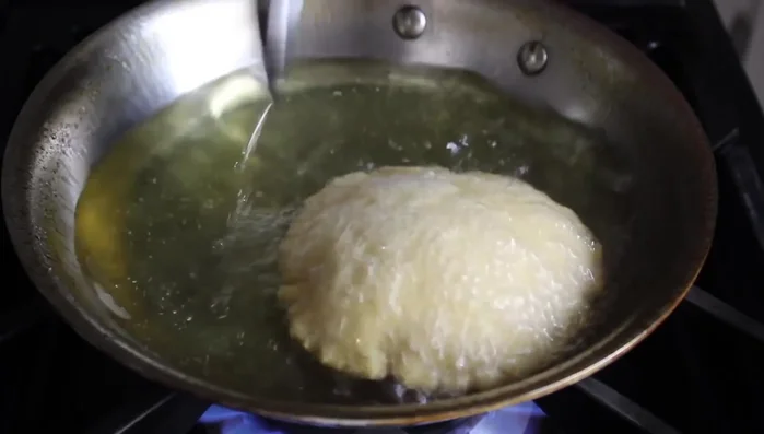 Once the tortilla puffs up, flip it and cook the other side for about 30 seconds.