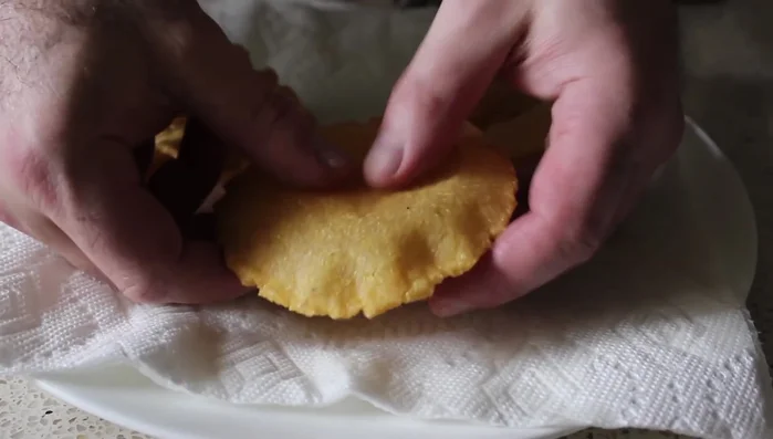 While still warm, gently press the center of the shell to create a space for filling.