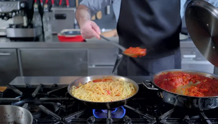 Toss pasta with tomato sauce, pasta water, butter, salt, and olive oil.