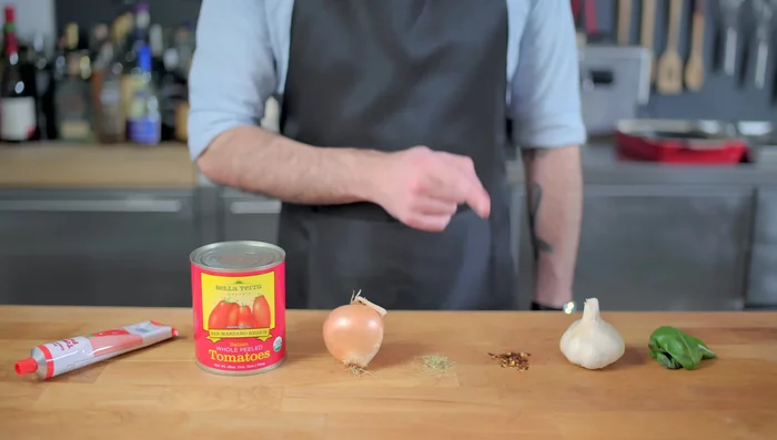 Make a simple tomato sauce. Chop basil, garlic, and onion.