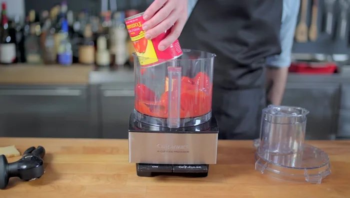 Chop San Marzano tomatoes in a food processor.
