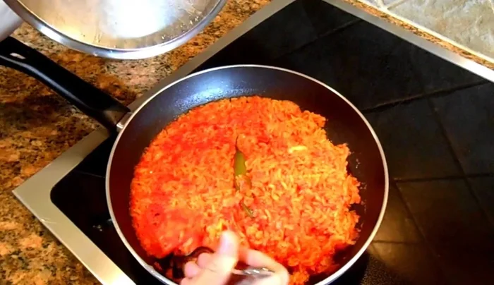 After 15 minutes, incorporate the remaining tomato puree into the rice, stirring gently to ensure even color.
