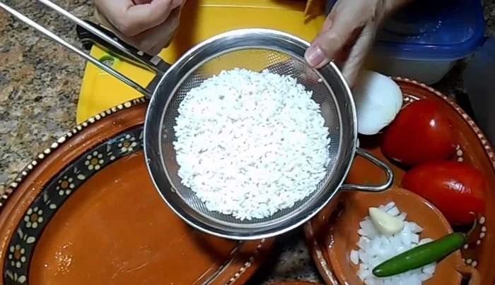 Wash 1 cup of long grain rice with warm water, then rinse with cold water until completely dry.