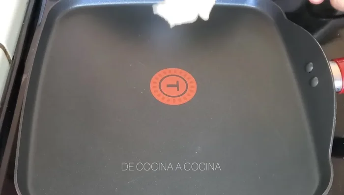 Heat tortillas on a comal, grill, or frying pan until slightly browned and softened.