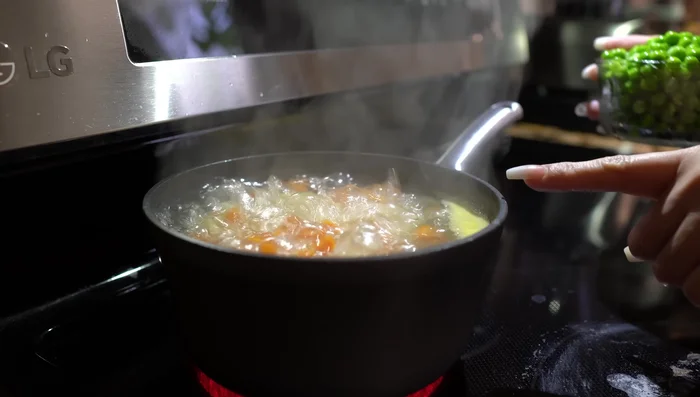 Add peas and continue boiling for another 6 minutes until everything is soft.