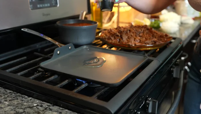 Heat a comal or skillet over medium heat. Add a little oil and dip corn tortillas into the consome. Cook until blistered on both sides.