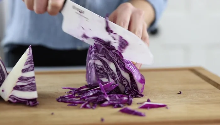 Shred cabbage and add to the dressing along with chopped cilantro. Stir and set aside.