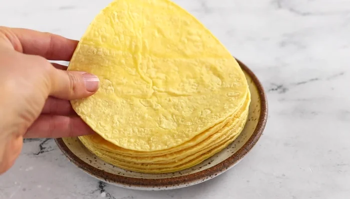Warm tortillas in a dry skillet or oven.