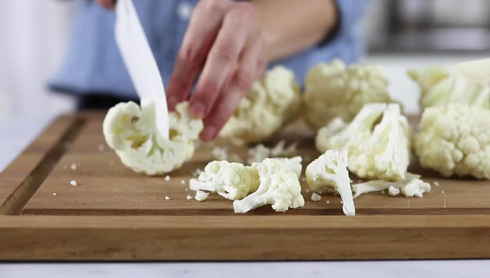 Toss cauliflower with olive oil in a large bowl.