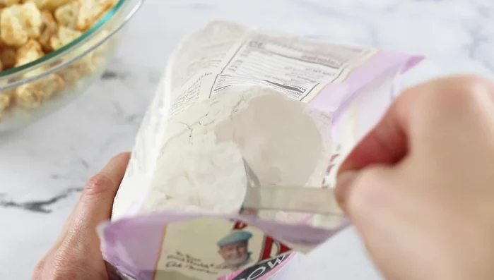 Optional: Add arrowroot or cornstarch for crispier cauliflower. Toss until powder disappears.