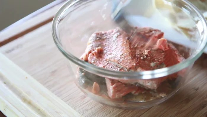 Mash the cooked salmon with a fork.