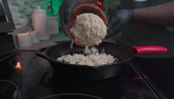 Place a large cast iron skillet on a stove set to medium-high heat. Add the ground mushrooms, spread them apart, and cook for 5-7 minutes.