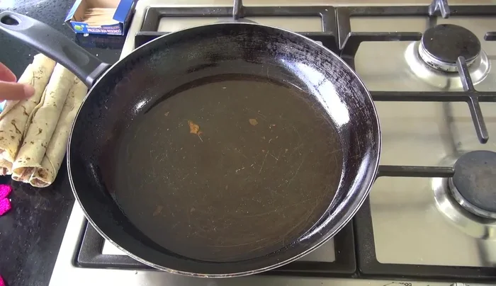 Once the oil is hot, carefully place the folded tacos into the hot oil.
