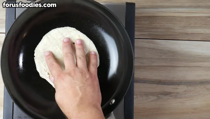 Heat tortillas in a hot pan for 5-10 seconds per side until pliable.