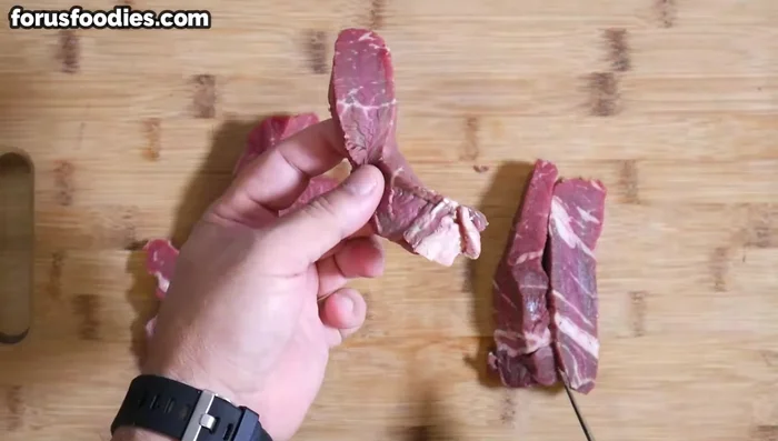 Cut the steak against the grain into bite-sized pieces.