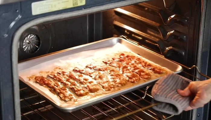 Remove bacon from oven and transfer to a paper towel-lined plate to drain. Crumble. (120.159)