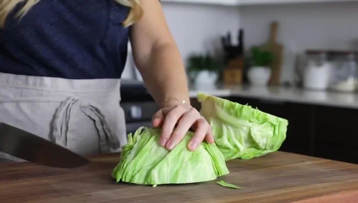 Make the slaw: Thinly slice cabbage and add to a large bowl with cilantro and crumbled bacon. (149.12)