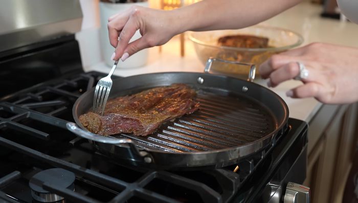 Cook the beef: Heat Comal or grill to high heat. Cook the marinated beef for 3 minutes per side. (324.539)
