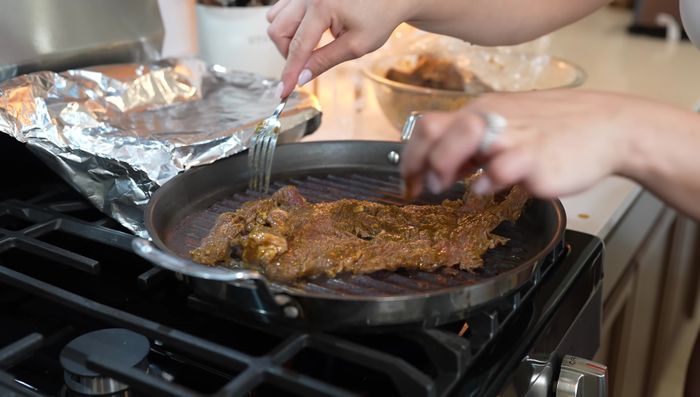 Rest and chop the beef: Let the cooked beef rest for 10 minutes, then chop against the grain into strips and small pieces. (358.02)