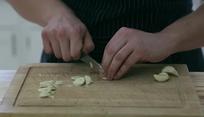 Slice 4-5 cloves of garlic.